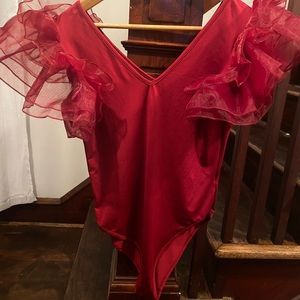 Red body suit with dramatic tulle sleeves